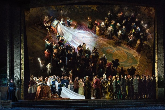 A crowd scene from ‘Medea’ by the Canadian Opera Company, reflected in a giant mirror behind the stage