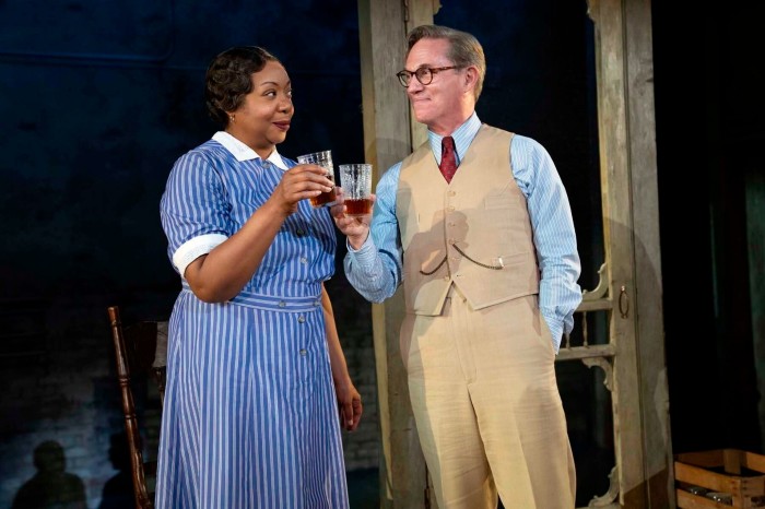 A male and female actor holding drinks glasses in a scene from ‘Harper Lee’s “To Kill a Mockingbird”’ 