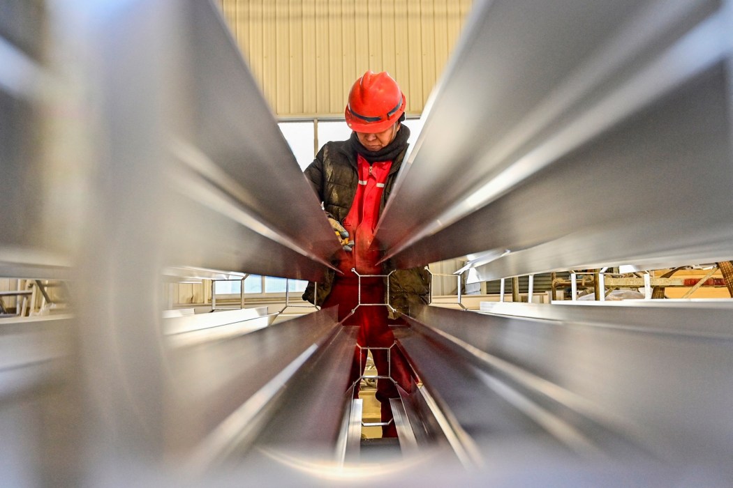 An employee works on a steel pipe at a factory in Weifang, in China's eastern Shandong province on January 31, 2024. Photo: China Out/AFP.
