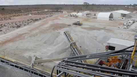 Ore falls from a conveyor on to a stockpile at the Bald Hill lithium mine site outside Widgiemooltha, Australia