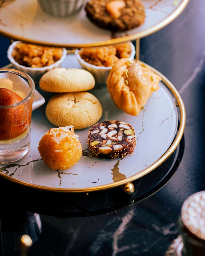 A variety of miniature Indian desserts come with the tea course at Mumbai