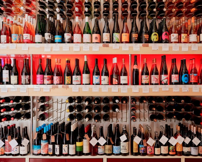 Shelves stacked with bottles of wine in a corner of Wine Therapy