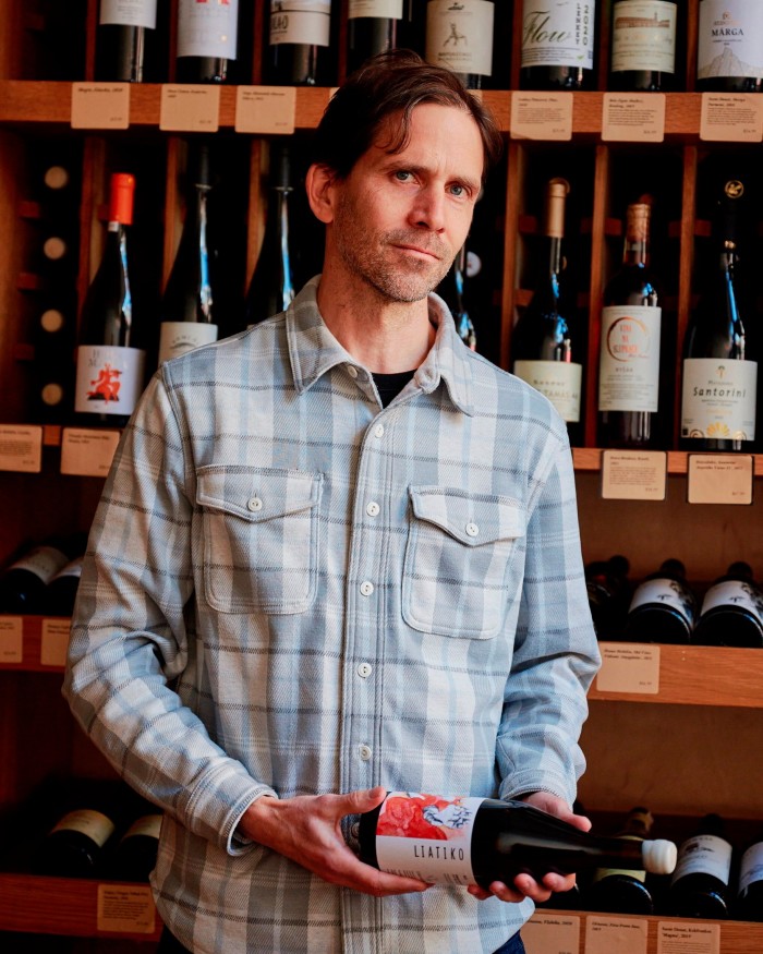 Flatiron’s Jeff Patten holding a bottle of wine