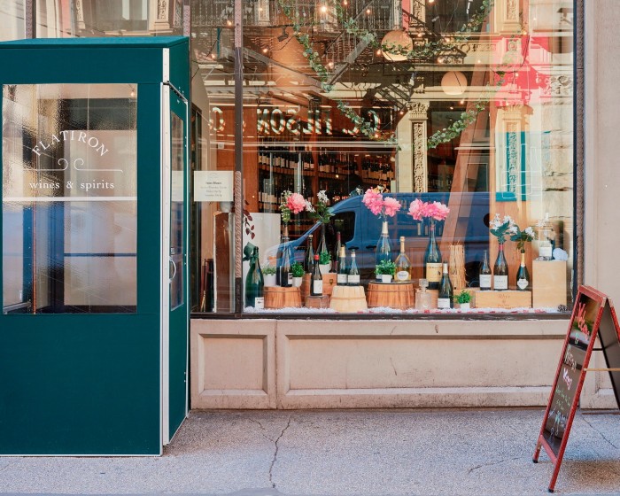 The facade of Flatiron Wines, with a green cabin protruding from the window