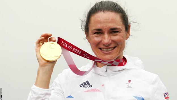 Dame Sarah Storey holds her gold medal