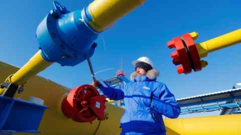 Am employee checking valves at a Russian gas pipeline