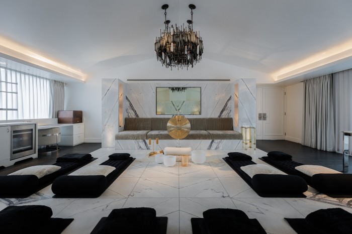 The Mandrake hotel’s penthouse suite set up for sound bathing, with black velvet mats dotted around a white marble floor in front of a gong and singing bowls