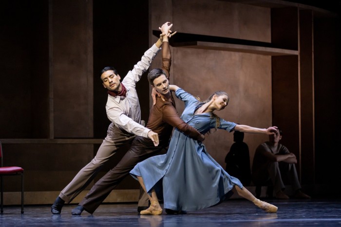 Two male and a female ballet dancer in contemporary clothing in Cathy Marston’s ‘The Cellist’