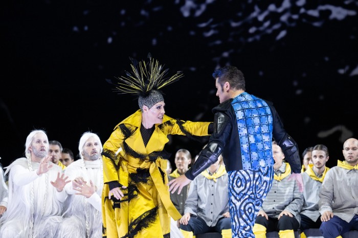 A scene from Opernhaus Zürich’s production of Puccini’s ‘Turandot’, with a soprano in a red and black robe and elaborate black headpiece