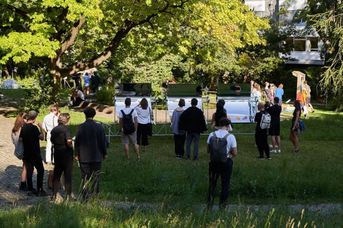 People looking at various installations, including mirrored ones, at the Design Biennale Zürich held in the city’s Old Botanical Garden 