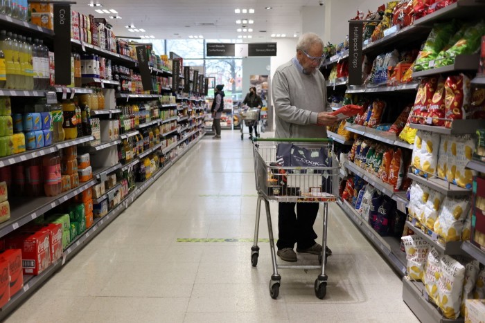 A man shops at a Waitrose supermarket