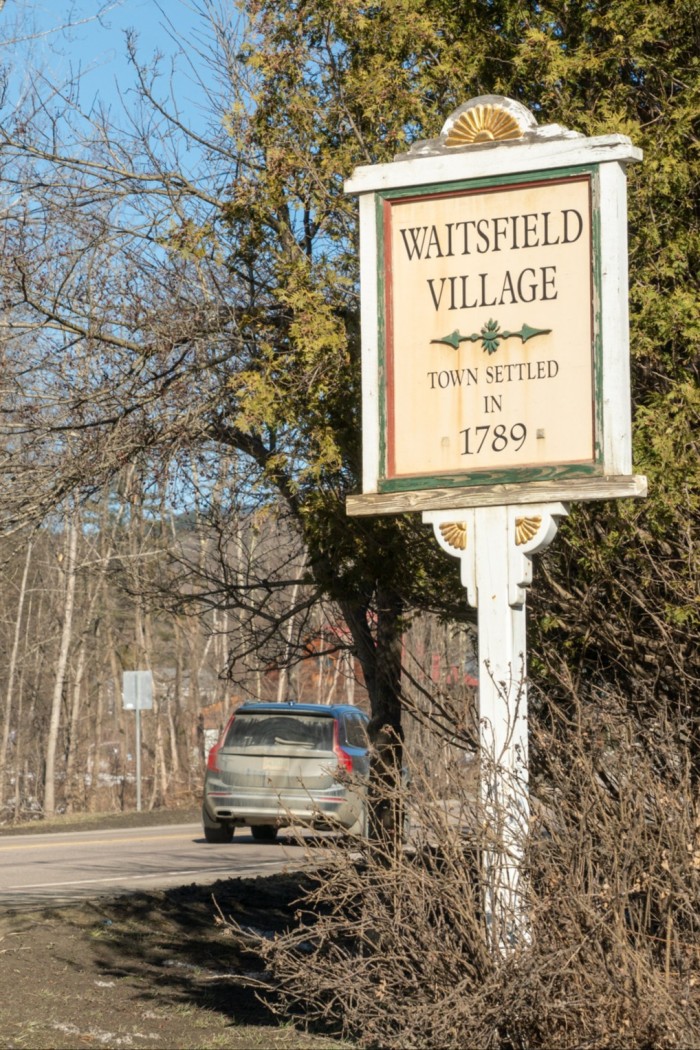 A car drives past a sign saying ‘Waitsfield Village, Town Settled in 1789’