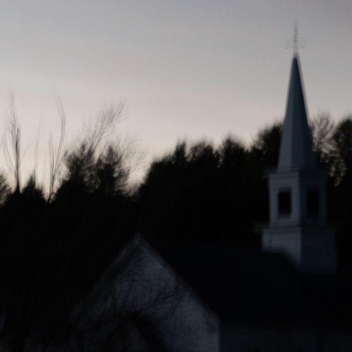 Trees and a church spire in half-light