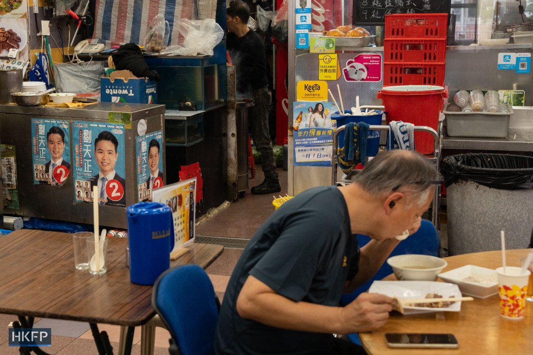 A District Council candidate's posters in a restaurant in Kennedy Town, on December 5, 2023. Photo: Kyle Lam/HKFP.