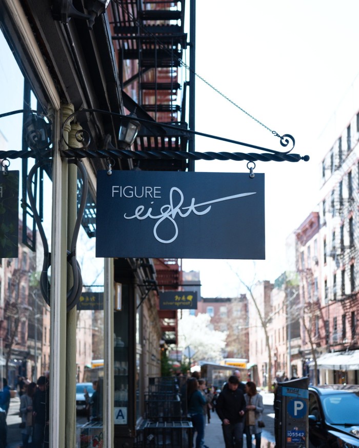 The facade of Figure Eight, with its sign hanging from a pole above the door