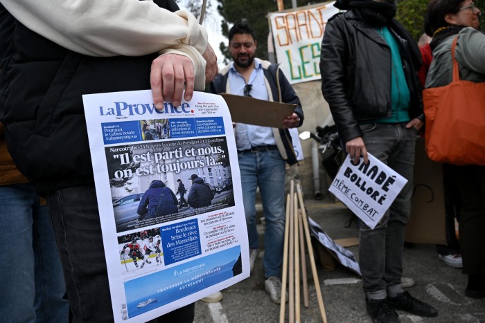 A journalist holds a front page of La Provence reading ‘he’s gone and we’re still here’ after the Marseille-headquartered paper’s editorial director was suspended following an article on French President Emmanuel Macron’s visit to the city