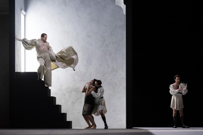 A scene from Oper Frankfurt’s staging of Handel’s ‘Giulio Cesare in Egitto’: the singer playing Caesar stands at the top of a short black staircase, 