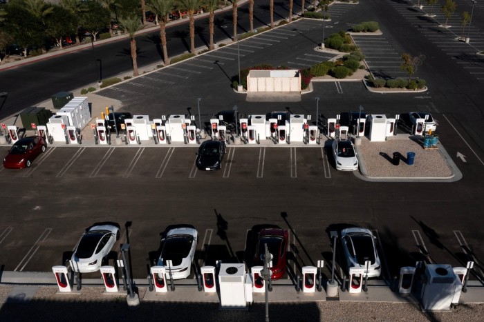 Motorists charge their vehicles at a Tesla Supercharger in Indio, California