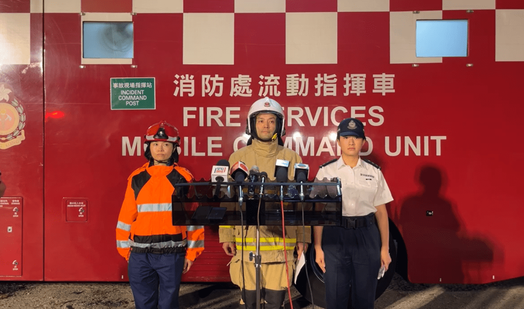 Fung San-yen (left) and Samuel Wong (centre) of the FSD and Mak Sze-wai of the police speak to reporters after a fire in Yuen Long on May 10, 2024. Photo: Screenshot via Fire Services Department livestream.