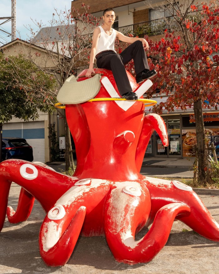 A woman sits on a giant red octopus