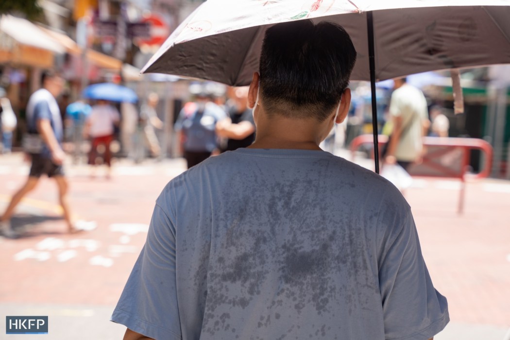 A man sweats while walking on the streets in Hong Kong.