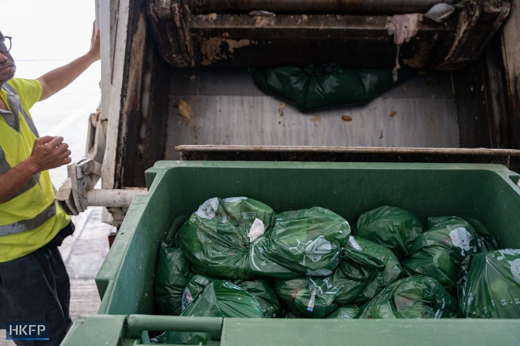 A sanitation worker loads bags of household waste into a garbage truck on April 8, 2024. File photo: Kyle Lam/HKFP.