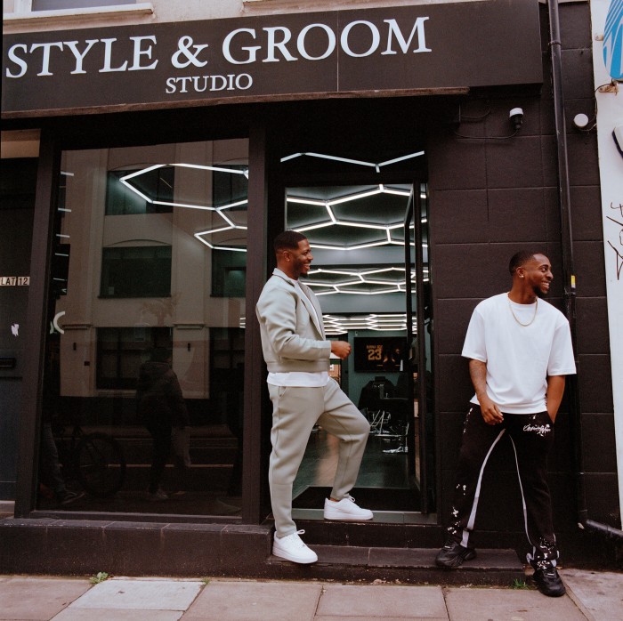 Yeboah, left, and his client Donell Odetola outside Style & Groom, North London