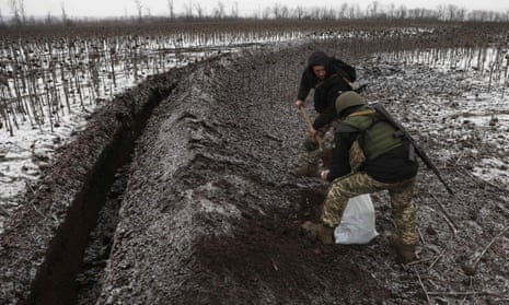 Ukrainian soldiers equip trenches on a field near Soledar on Saturday