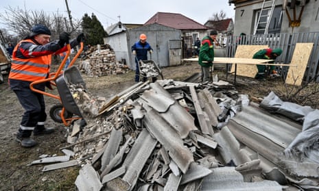 Workers remove rubble in Zaporizhzhia on Thursday after a Russian rocket attack that left 39 houses damaged