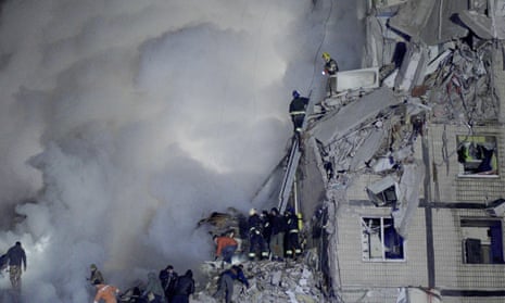 Rescuers works on a residential building destroyed after a missile strike, in Dnipro.