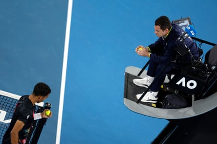 Felix Auger-Aliassime questions the chair umpire about the condition of the balls.