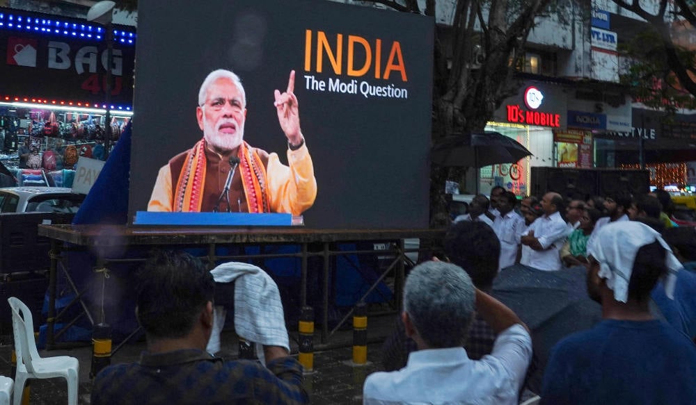 People watch the BBC documentary "India: The Modi Question", on a screen installed at the Marine Drive junction under the direction of the district Congress committee, in Kochi on January 24, 2023. (AFP)
