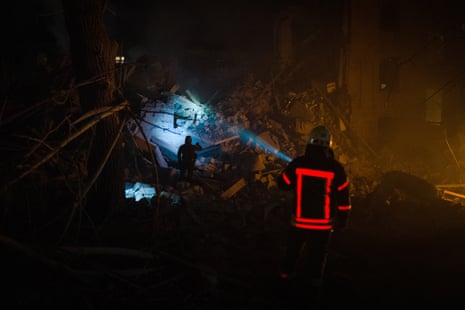 A rescuer shines a flashlight during search and rescue operations in Kramatorsk.