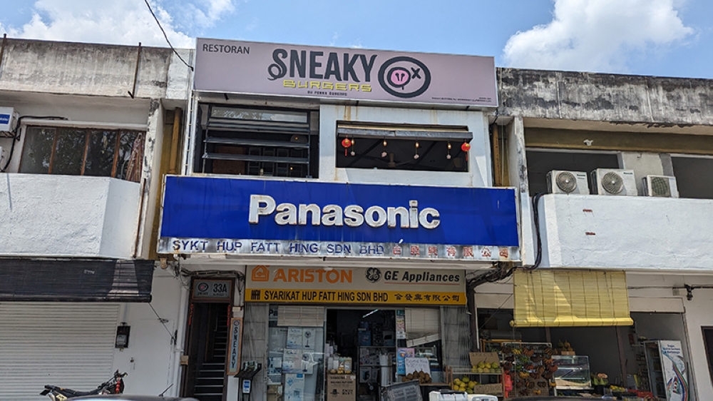Look up! You'll find Sneaky Burgers atop an electrical appliances store with a big blue Panasonic sign at Damansara Jaya.