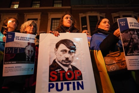 People hold banners during a silent candlelight vigil to show support for Ukraine in New York City, New York.
