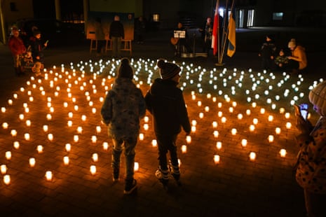 Ukrainian refugees and locals gather for ‘Light for Ukraine’ ceremony in the village of Grabie, Wieliczka, Poland.