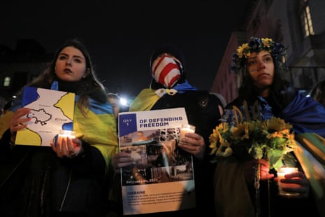 People attend a candlelight vigil in front of the Russian embassy in New York City, New York.