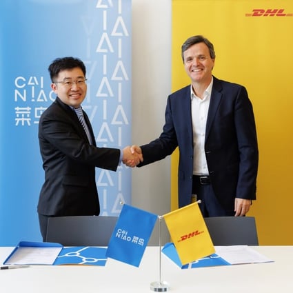William Xiong (left), Cainiao’s chief strategy officer and general manager for Europe and Southeast Asia, signs an agreement with Pablo Ciano, CEO of DHL eCommerce Solutions, that will see the companies combine their parcel locker networks in Poland. Photo: Handout