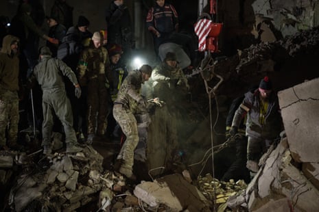 Ukrainian military members and local people conduct a search and rescue operation on 2 February in Kramatorsk.