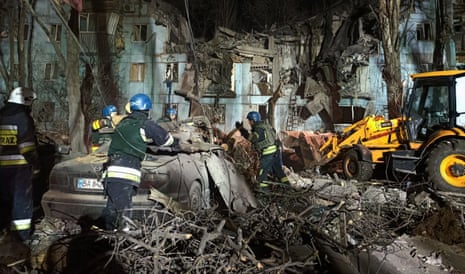 Rescuers work on a residential building destroyed after a missile strike in Zaporizhzhia.