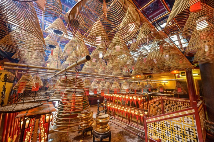 Dozens of wicker lanterns hanging from the ceiling in Man Mo Temple