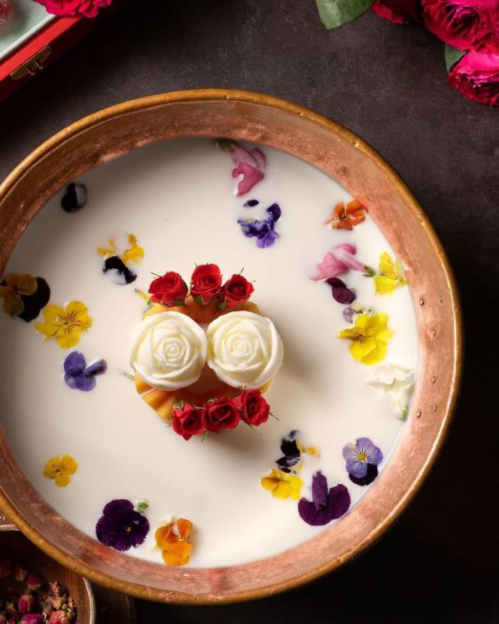 A bowl of milk soup on top of which float rosebuds and petals at Victorian Era