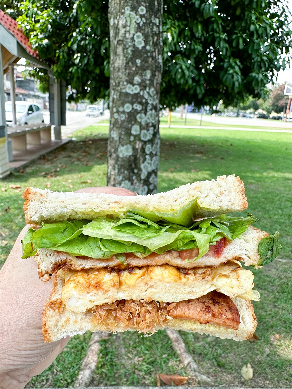 The signature egg sandwich has layers of vegetarian ham and vegetarian meat floss with egg, vegetables and that distinct sweet Taiwanese sauce
