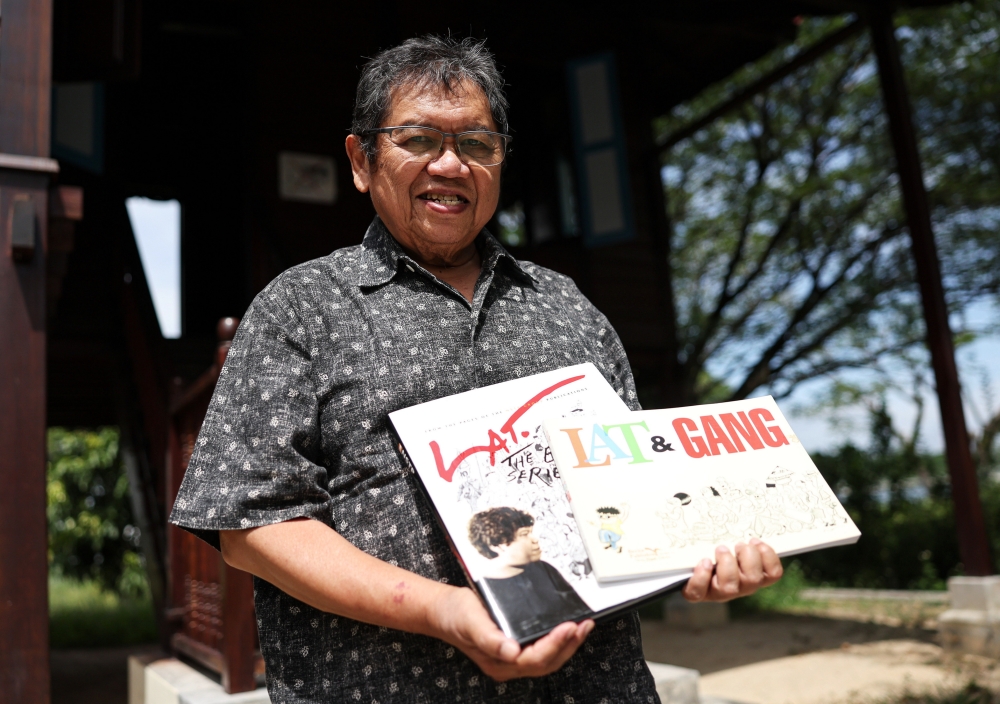 Cartoonist Datuk Mohd Nor Khalid, also known as Datuk Lat, poses with copies of his comics during a Bernama interview at Rumah Lat dan Galeri, Batu Gajah May 28, 2023. — Bernama pic