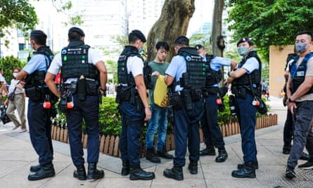 A man is stopped and searched by police officers at Causeway Bay near Victoria Park on Sunday