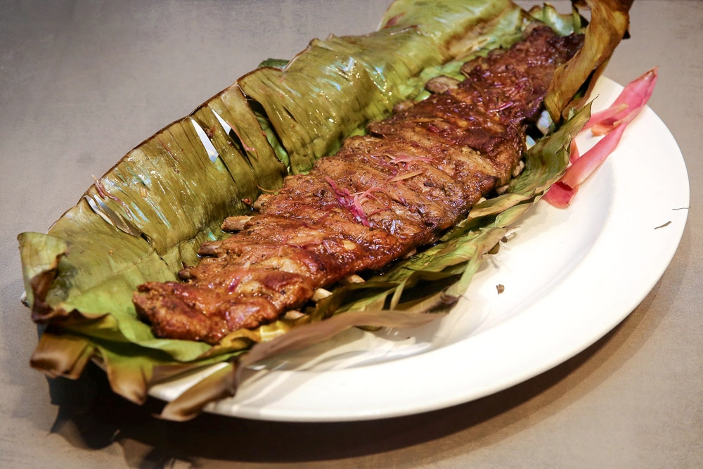 Iberico pork ribs wrapped in banana leaves and flavoured with ‘bunga kantan’ (torch ginger flowers). — Picture by Yusof Mat Isa