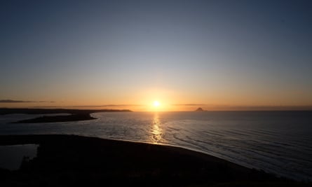 The sun rising over the ocean in New zealand