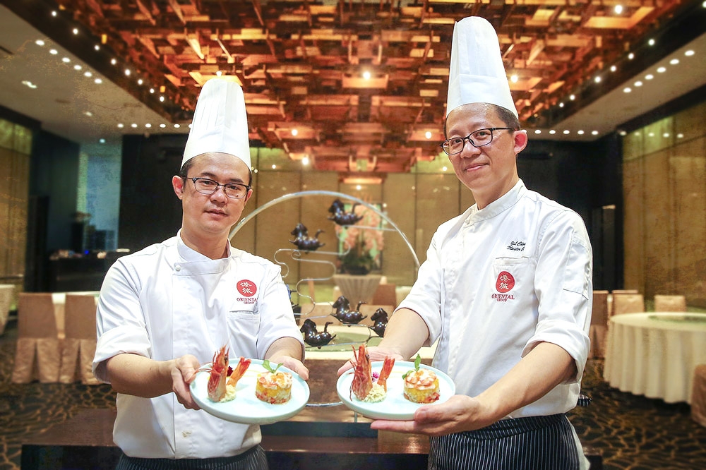 Chef Roy Yam (left) and Chef Alex Chong (right) present The Oriental Group of Restaurants’ new Chef Recommended dish. — Picture by Yusof Mat Isa