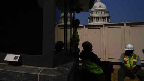 Workers outside the US Capitol building