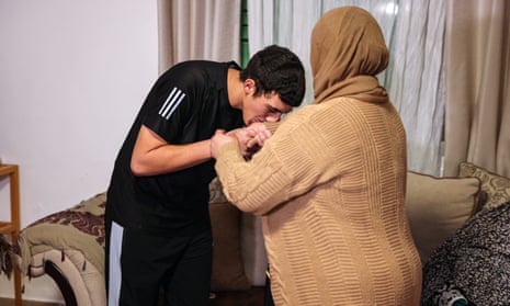 Palestinian Muhammad Abu Al-Humus kisses his mother after returning to his home in east Jerusalem in the early hours of Tuesday.